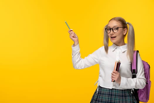 world book day smiling happy student with pony tails in uniform holding pencils