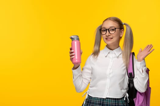 world book day smiling school girl with thermos and backpack