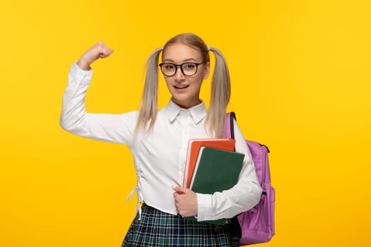 world book day strong schoolgirl smiling and holding books