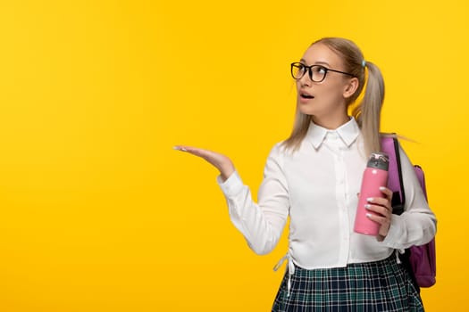 world book day surprised school girl with pink thermos and glasses