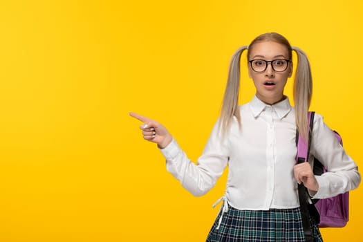 world book day surprised school girl with pony tails in white shirt and pink backpack