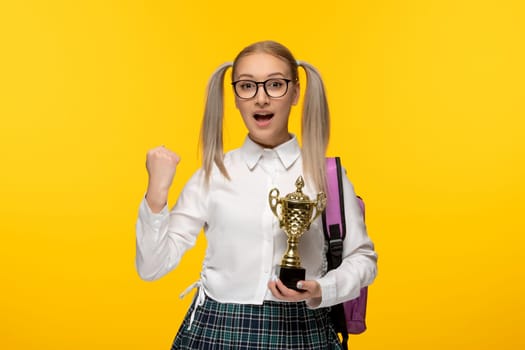 world book day winner schoolgirl holding a golden trophy