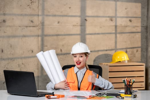 engineer blonde young cute smart girl civil worker in helmet and vest very excited and proud