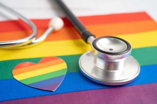 Black stethoscope on rainbow flag with heart, symbol of LGBT pride month celebrate annual in June social, symbol of gay, lesbian, bisexual, transgender, human rights and peace.