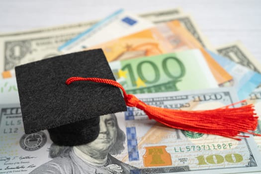 Graduation gap hat on Euro and US dollar banknotes money, Education study fee learning teach concept.