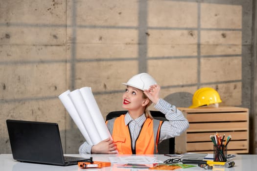 engineer cute young blonde smart girl civil worker in helmet and vest happy