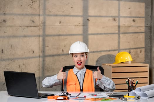 engineer cute young blonde smart girl civil worker in helmet and vest happy and cheerful