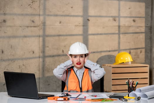engineer smart young cute blonde girl civil worker in helmet and vest annoyed and mad