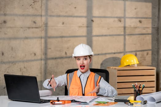 engineer young smart cute blonde girl civil worker in helmet and vest with new project