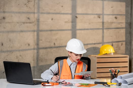 engineer civil worker in helmet and vest smart young cute blonde girl