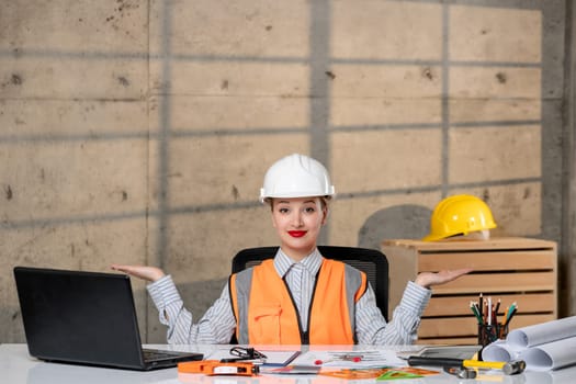 engineer civil worker in helmet and vest smart young cute blonde girl excited about plan