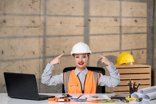 engineer civil worker in helmet and vest smart young cute blonde girl very proud