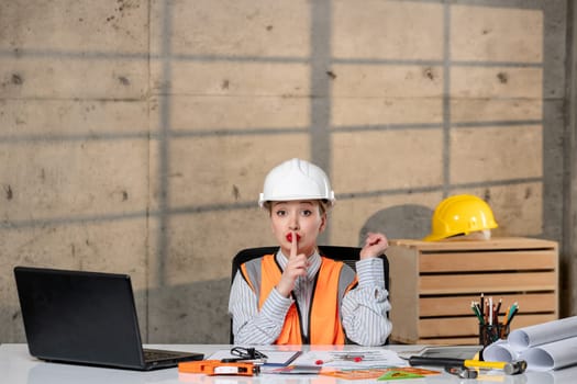 engineer in helmet and vest civil worker smart young cute blonde girl being quiet