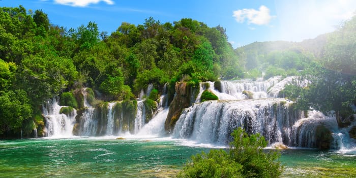 Beautiful Waterfall background in sunny summer day. Beautiful Waterfall In Krka National Park - Croatia, Europe. Krka river waterfalls in the Krka National Park