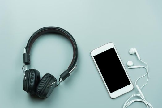 mobile and earphones on gray background