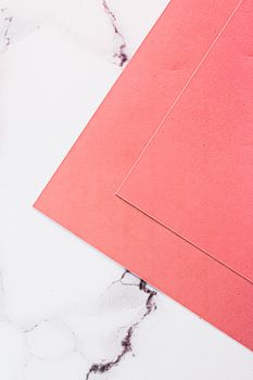 Pink A4 papers on white marble background as office stationery flatlay, luxury branding flat lay and brand identity design for mockups