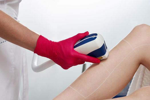 Female legs, woman in professional beauty clinic during laser hair removal