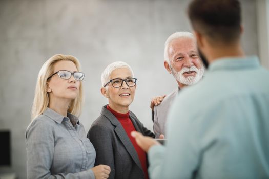 Portrait of a confident senior businesswoman during discussion at the meeting in a modern office.