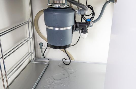 Waste disposal leak under sink, broken garbage chopper