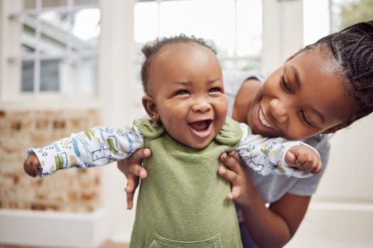 Love, woman with baby and in living room smile at their home. Happy family or care, happiness or comic and black female person with newborn laughing or smiling at their house indoors for support.