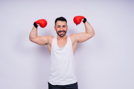 Man boxer in red sport boxing gloves at a studio, copy space.