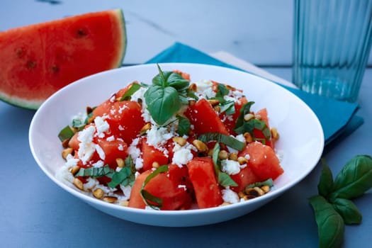Summer salad with watermelon and feta cheese on a garden table. High quality photo
