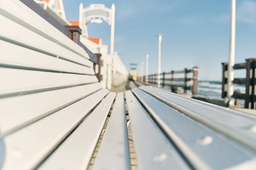 White bench on the boardwalk. Baltic Sea. The beach of Zelenogradsk. Kaliningrad region. High quality photo