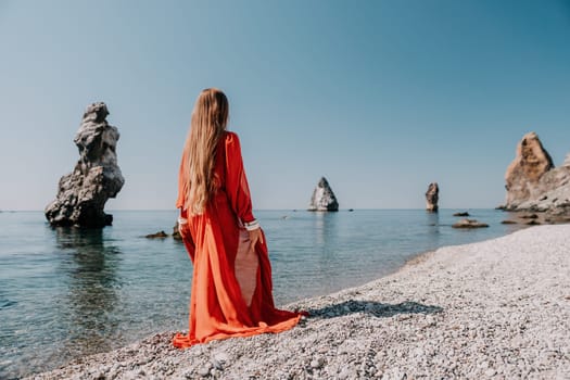 Woman travel sea. Happy tourist taking picture outdoors for memories. Woman traveler looks at the edge of the cliff on the sea bay of mountains, sharing travel adventure journey.