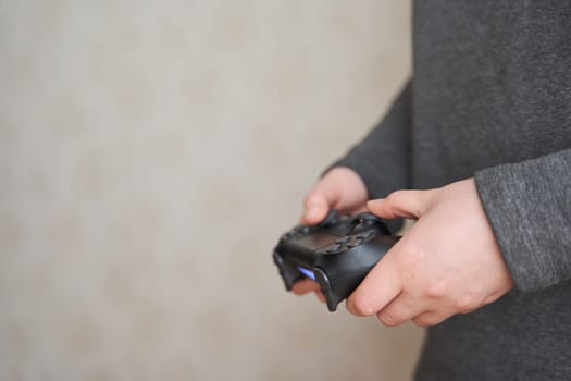 Gamer girl. Joystick for game console. The girl plays in the console. Close-up. Girl holding a joystick for a game console