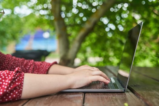 An open laptop stands on a wooden table. High-quality photo