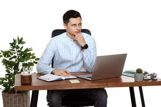 handsome man using laptop computer for work at table on white background