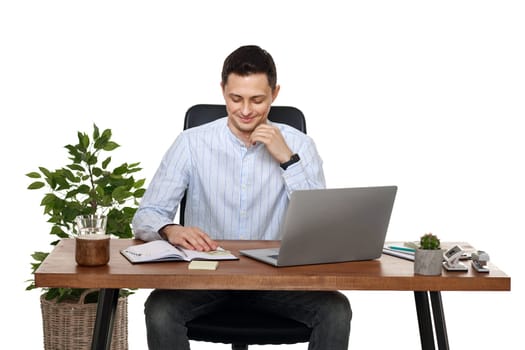 young man using laptop computer for online work at table on white background