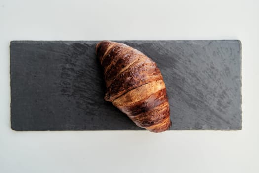 Croissant on a black tray top view. High-quality photo