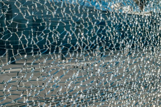 Shattered glass background with spider web pattern and water droplets.