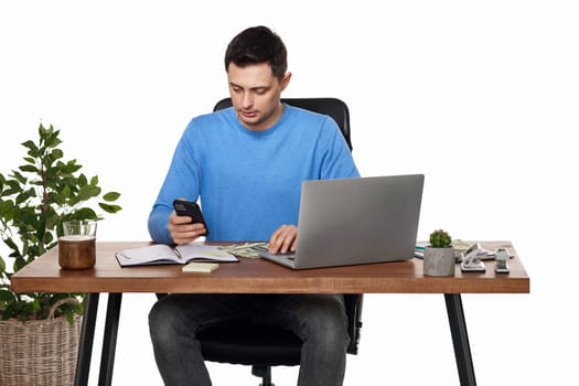 handsome businessman working with laptop and using smartphone on white background