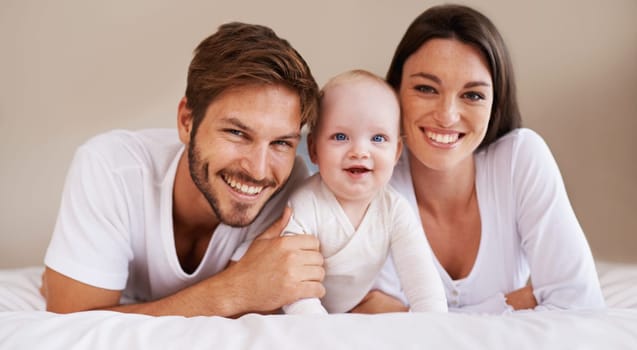 Happy portrait, dad and mom of baby kid on bed for love, care and quality time together to relax at home. Smile of family, parents and cute newborn child for development, caring support and happiness.