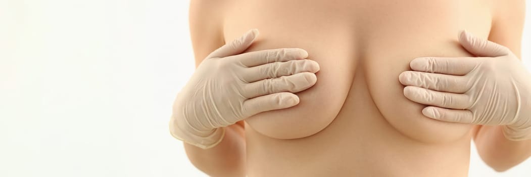 Body of beautiful woman covering large breasts. Plastic surgery and breast augmentation and lift