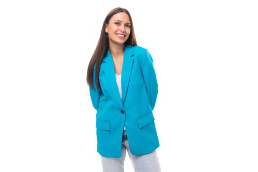 young successful office worker woman with black straight hair in a blue business jacket on a white background with copy space.