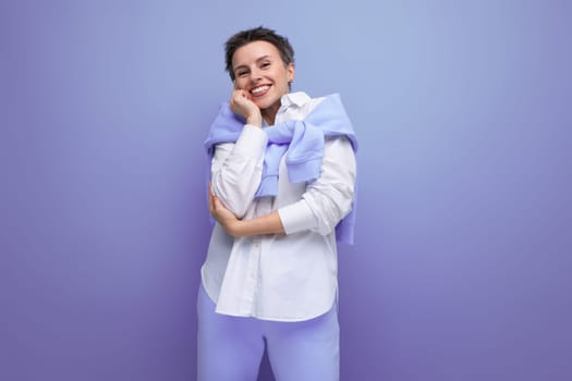 kind young dark-haired woman with sticking hair in a white shirt.