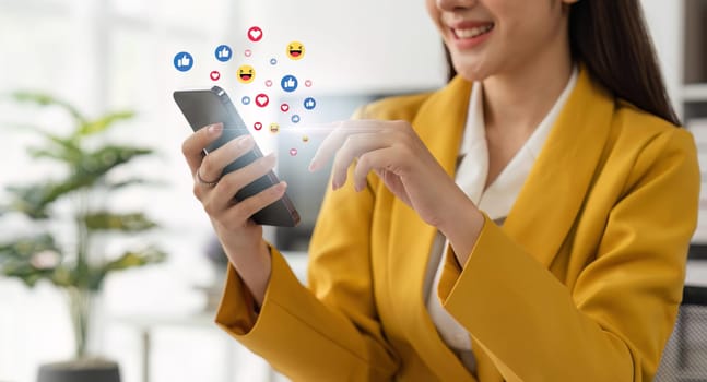 Mobile Application. business woman touching mobile smart phone with graphic social network notification icon diagram, internet connection, social media, digital online technology concept.