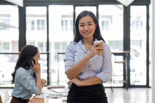 Young asian business woman entrepreneur looking at camera in the office.