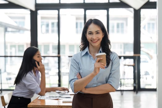 Young asian business woman entrepreneur looking at camera in the office.