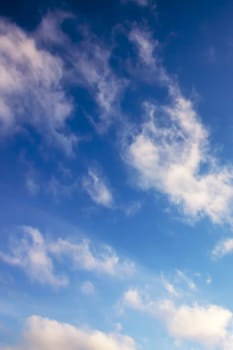 Clouds in bright blue sky nature background or texture