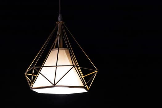 Designer garden pendant lamp hanging outdoor terrace during in the dark.