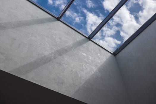 The second light in the interior, a window on the ceiling with a cloudy sky behind it.