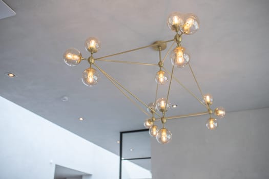 Modern loft chandelier in modern luxury minimalist light interior.