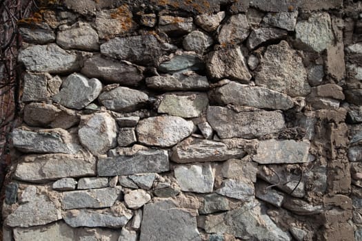 Medieval grunge background of natural stones bonded with cement mortar.
