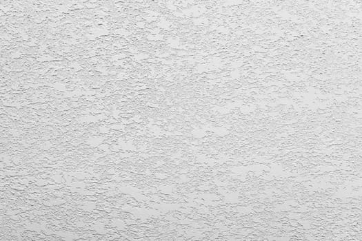 White-gray uniform background of decorative multilayer plaster on the wall, grunge background.