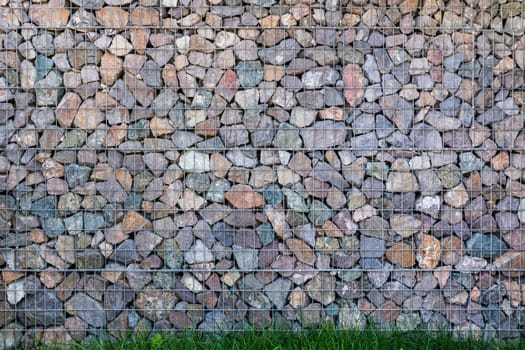 Wall of gabions background, natural stones in gardering.