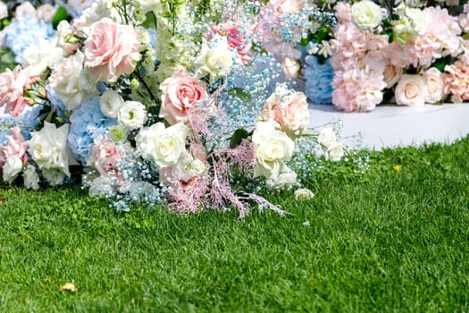 Green summer lawn and part of festive wedding flower decorations, copy space.